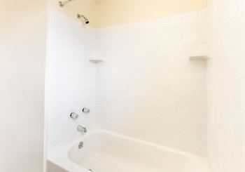 Bathroom with white tiles and a white bathtub at Foxridge Townhomes, Maryland